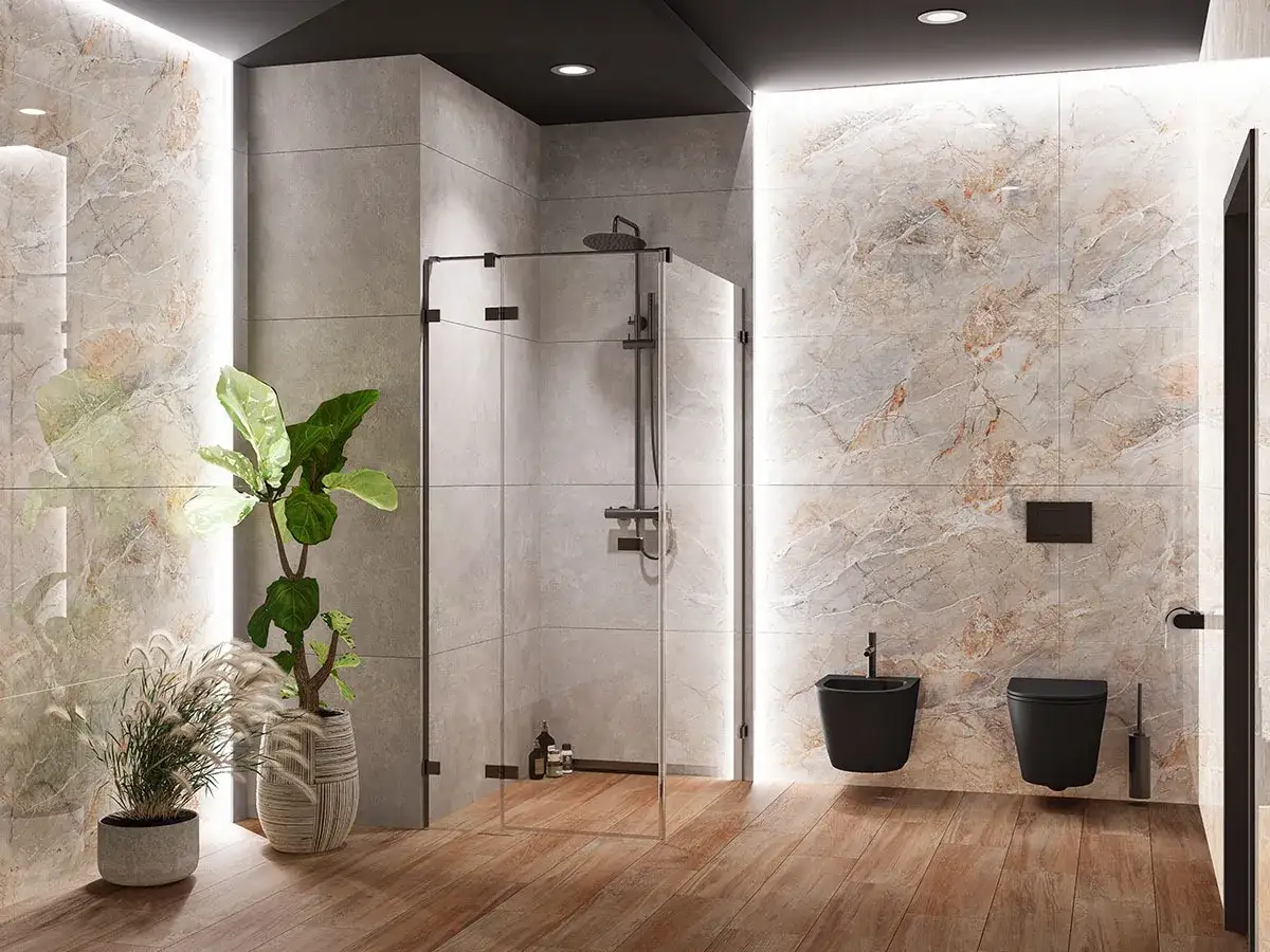 Nowoczesna łazienka z prysznicem typu deszczownica, której mocowanie do ściany jest dyskretne. Obok wisząca czarna miska WC i bidet.